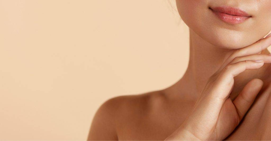 Closeup of a young woman touching her chin