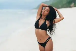 Slender Sexy Dark Skinned Girl In Swimwear Posing On Beach With Sand